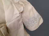 a close up of a white shirt with a floral design on it