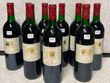 six bottles of wine are lined up on a counter