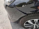 a man that is standing next to a car