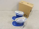 pair of blue and white rain boots sitting next to a cardboard box