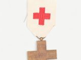 a medal with a cross on it and a red cross on it