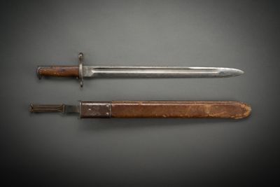 an old knife and a wooden sheath on a black background