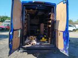 a blue van that is parked in the dirt