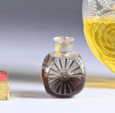 a small bottle of liquid next to a small bottle of liquid