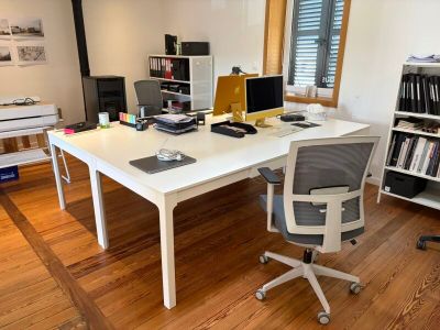 a white desk with a computer on it in a room