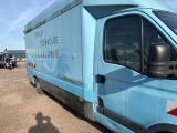 a blue van that is parked in a parking lot