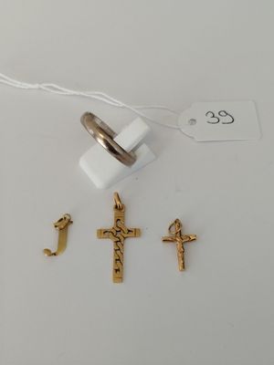 a close up of a ring with a cross on it next to other items