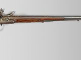 an old gun with a wooden barrel and a metal handle