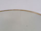 a close up of a white bowl with gold trim on a table