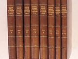 six livres marron sont alignés sur une surface blanche