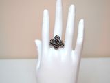 a ring that is sitting on a mannequin ' s hand