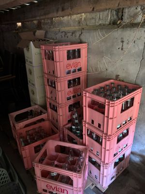several pink crates are stacked on top of each other in a garage