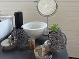 a table with a sink, mirror, and other items on it