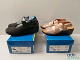 two pairs of women ' s shoes sitting on top of boxes