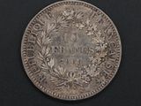 a close up of a coin on a black surface