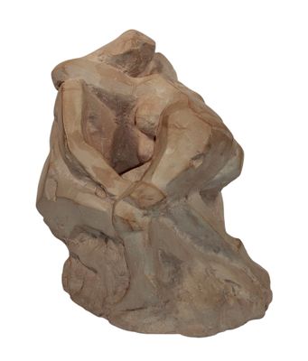 statue of a woman sitting on a rock with her hands on her knees