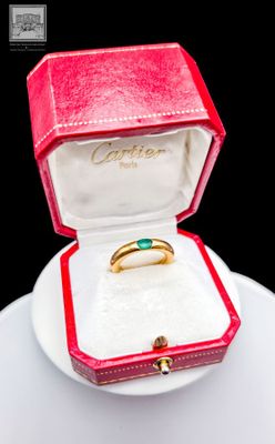 a red box with a gold ring inside of it