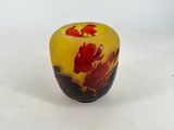 yellow and red glass vase with a red flower on it