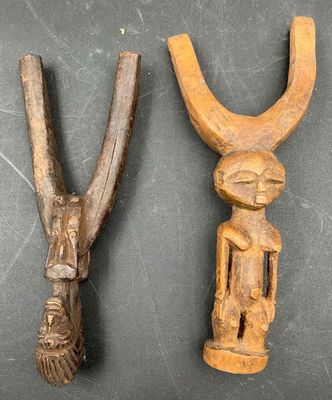 two old wooden tools sitting next to each other on top of a table