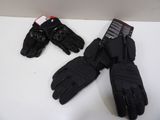 two pairs of black gloves sitting on top of a white table