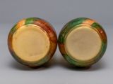 two vases sitting side by side on a table
