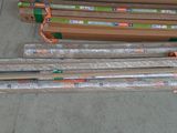 many rolls of plastic wrap on the ground next to a box