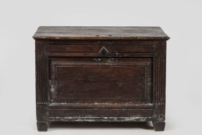 an old wooden chest with a drawer on top of it