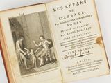 an old book with a picture of a man and a woman sitting at a table