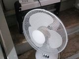 a fan that is sitting on the steps in front of a door