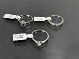 three rings with price tags on them sitting on a table