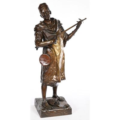 a bronze statue of a man with a guitar on a marble base