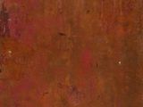 an old, rusted suitcase sitting on top of a wooden floor