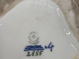 a white vase with a blue and white design on it