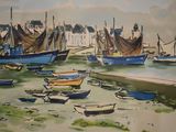 many boats that are sitting in the water by the shore
