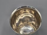 a silver cup that is sitting on a table