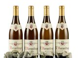 three bottles of wine sitting next to each other on a white surface