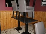 three chairs sitting at a table in the middle of a room