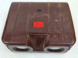 a brown case with a red light on top of it
