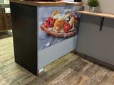 a picture of a counter with a laptop on top of it