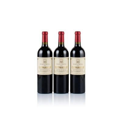 three bottles of red wine sitting next to each other on a white surface