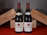two bottles of wine sitting next to each other on a table