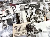 several old black and white photographs of people and animals on a table