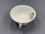 a white bowl with a floral design on it