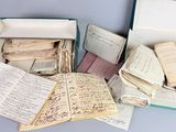 an open box filled with lots of old papers sitting on top of a table