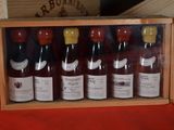 bottles of wine in a wooden box on a table