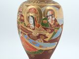 a vase with a picture of a woman and a man on it