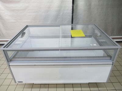 a glass display case with a yellow sticker on it