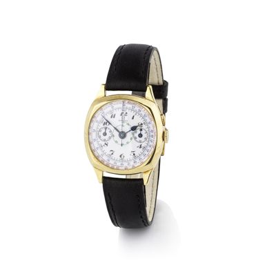 une photo d'une montre en or et diamants montée sur un bracelet en cuir noir
