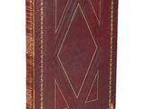 a brown leather book with a diamond design on the cover