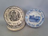 two blue and white plates with a picture of a boat on them